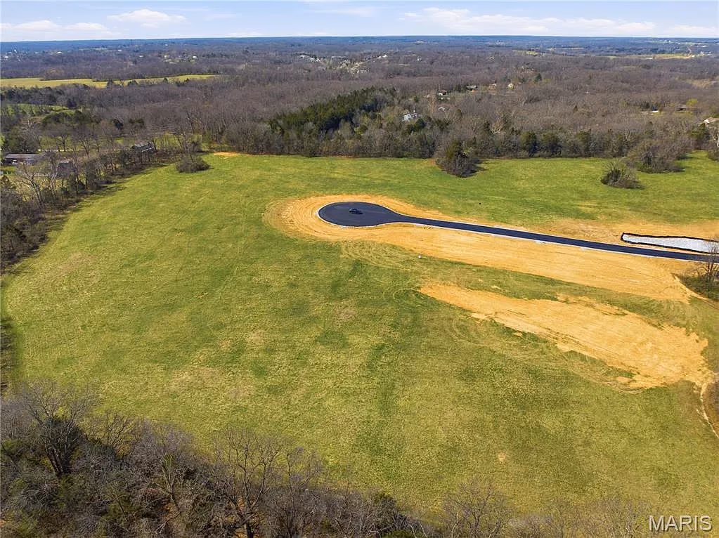 Meadow homesite with a paved cul-de-sac and rolling countryside beyond