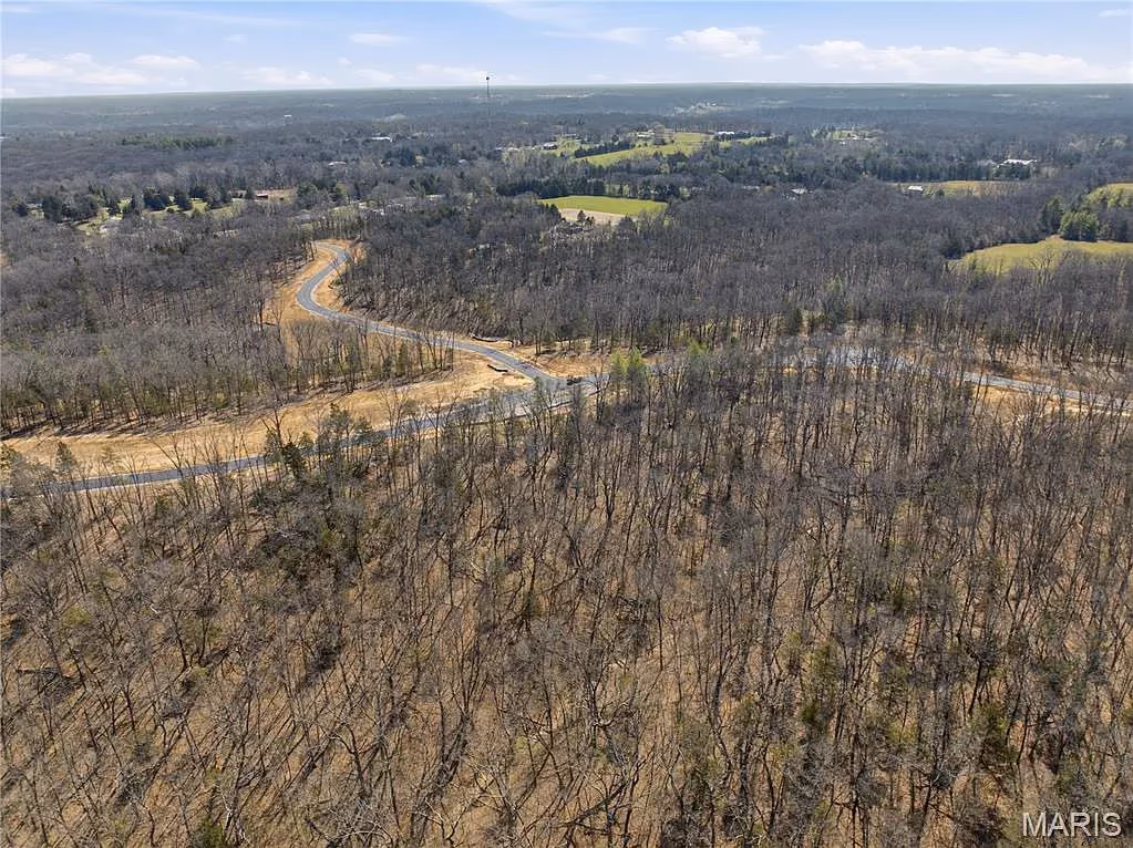 Panoramic view across forested valley and distant fields